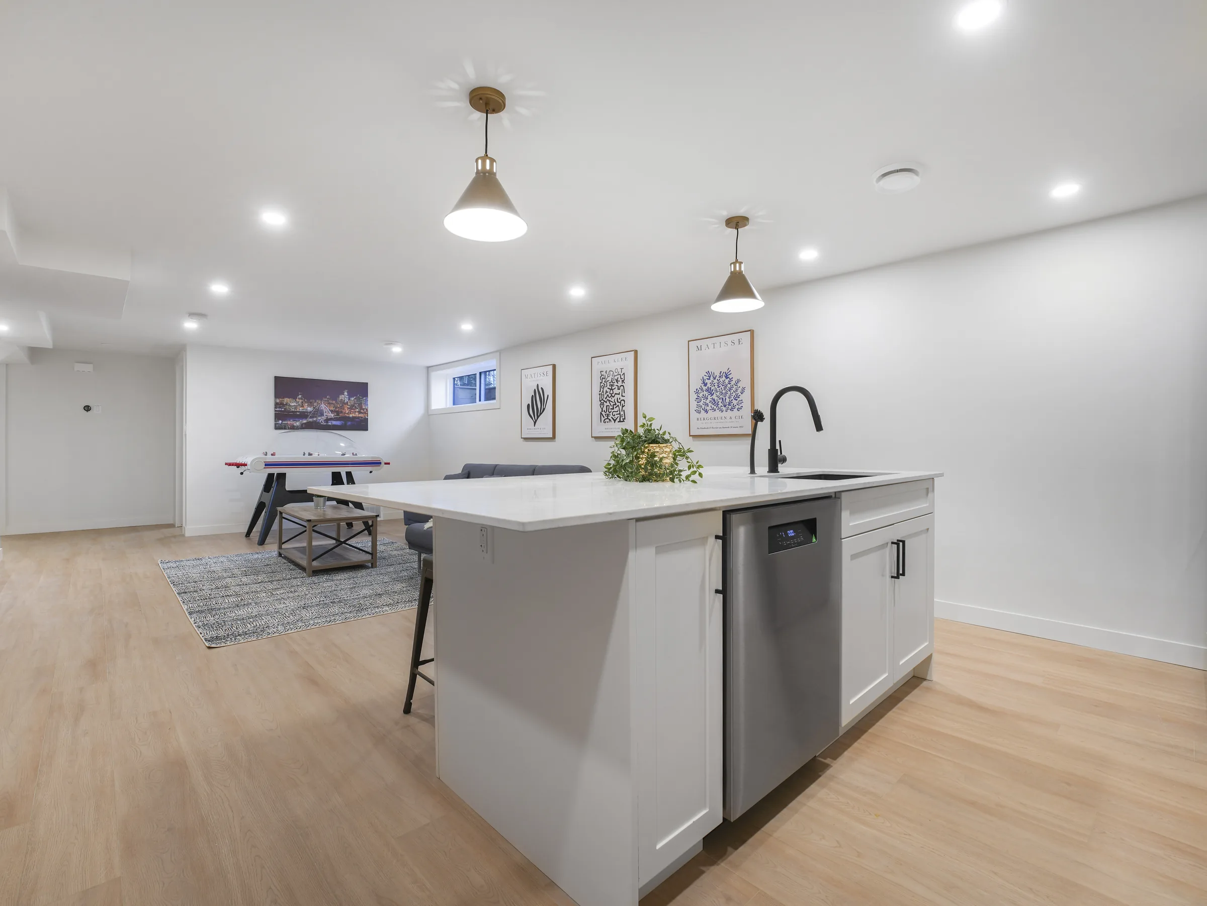 Kitchen wide angle with the rec room and island in the foreground
