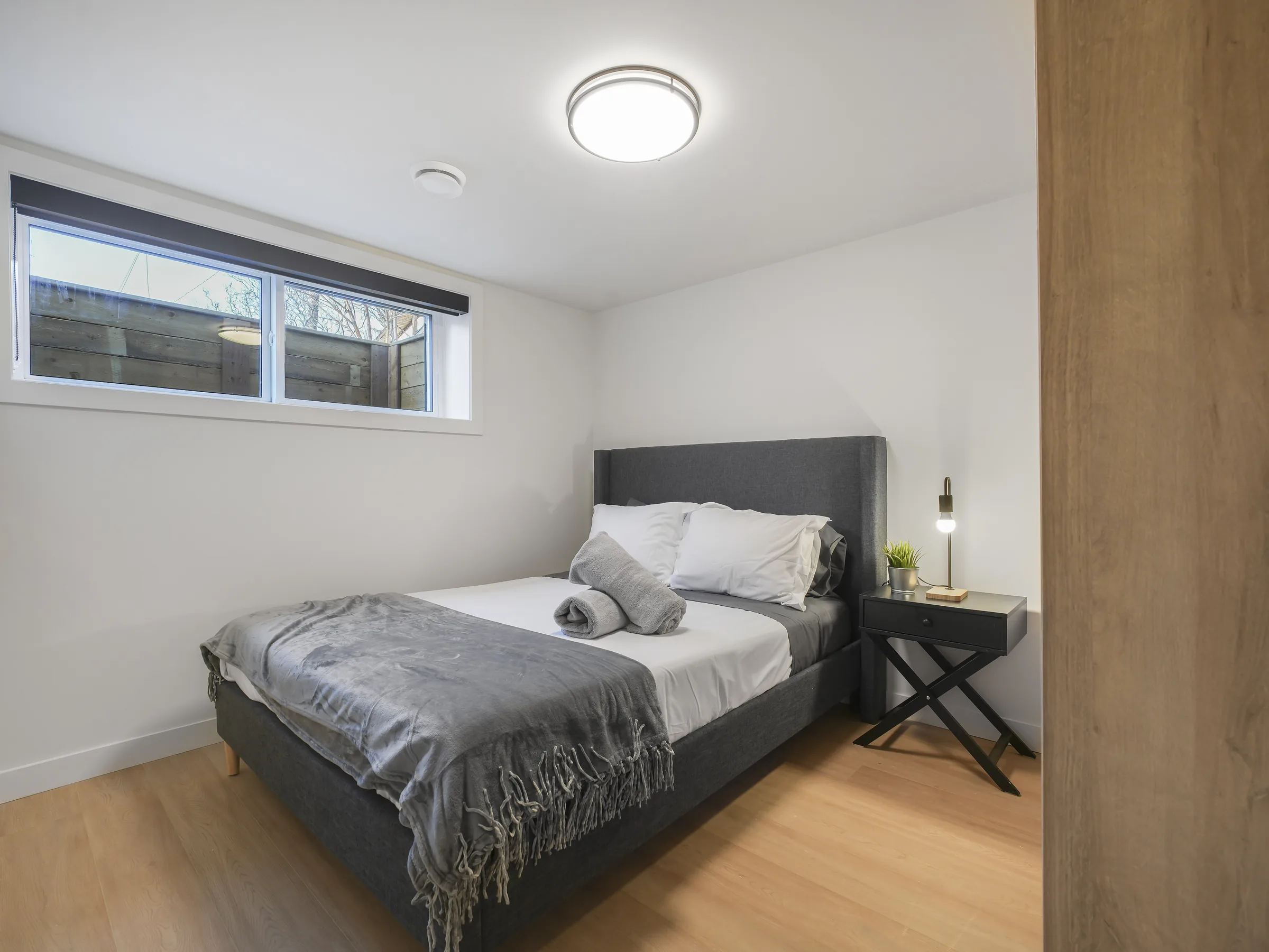 Bedroom with wardrobe closet and window well