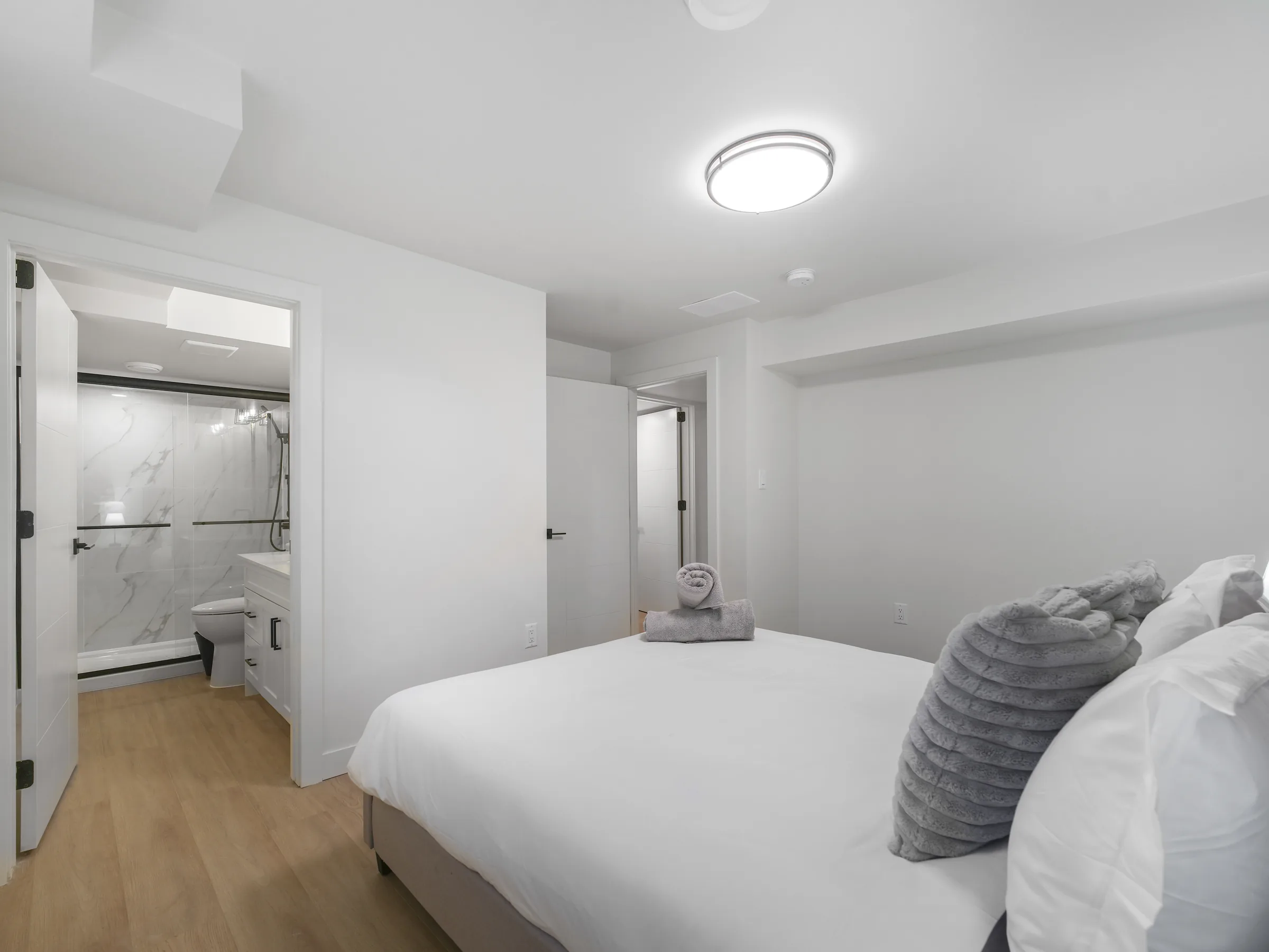 Third bedroom with ensuite bathroom visible through the open door