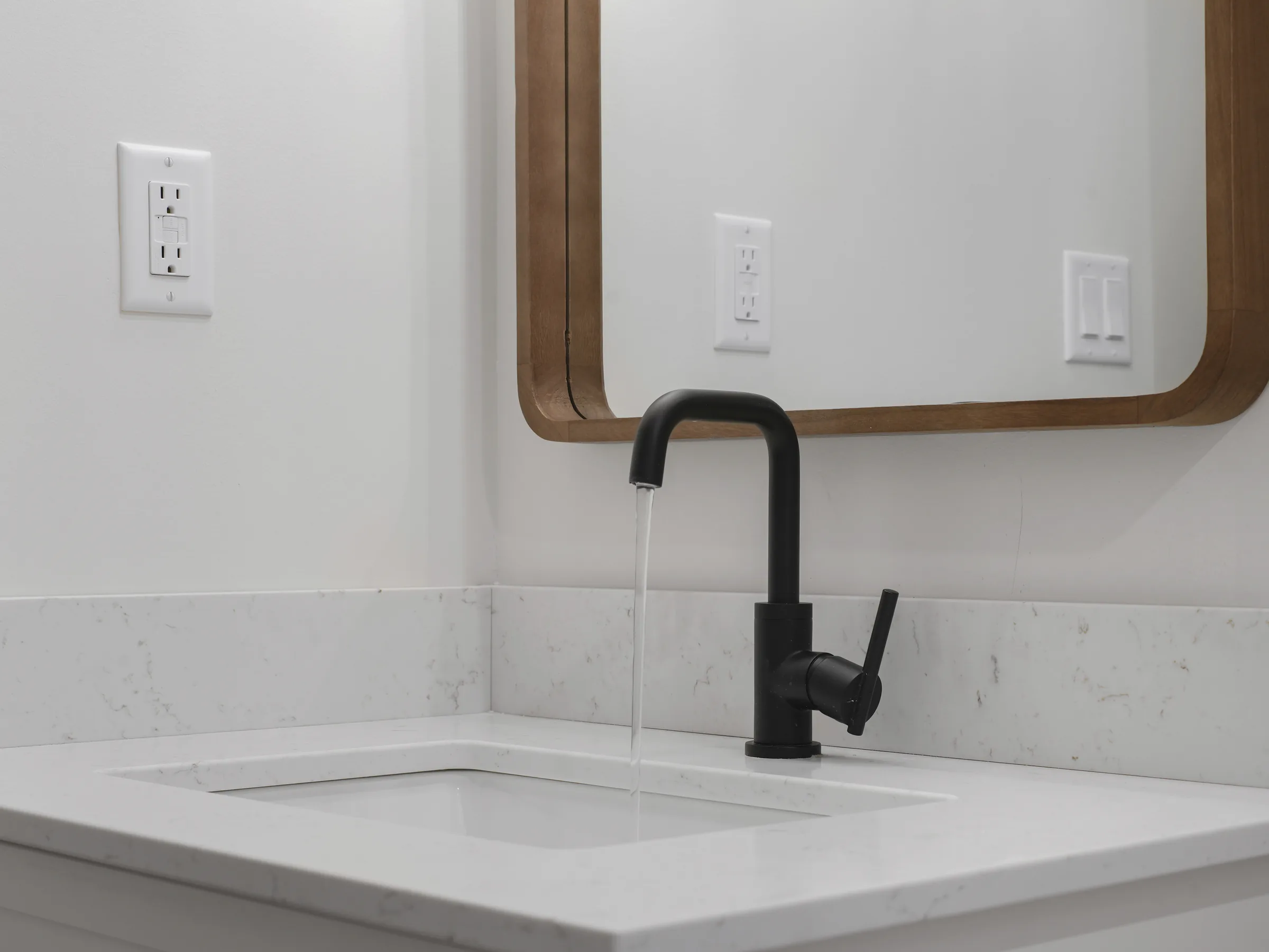 Bathroom faucet close-up on the white vanity