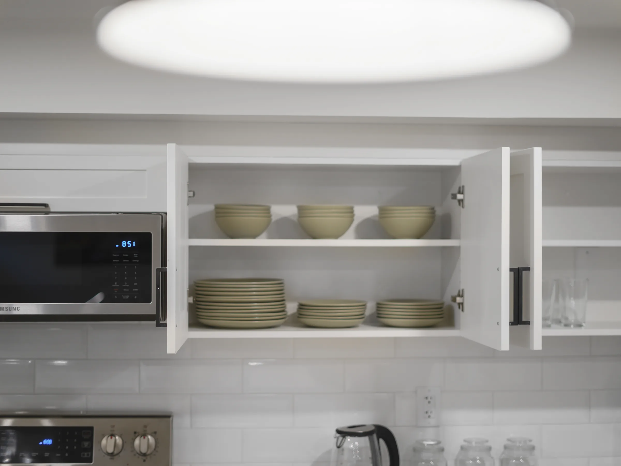Open cabinet showing bowls and plates
