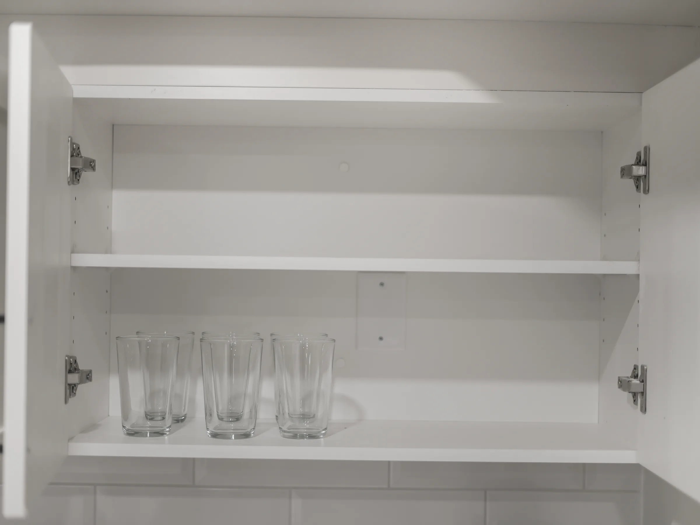 Cabinet with wine glasses and tumblers