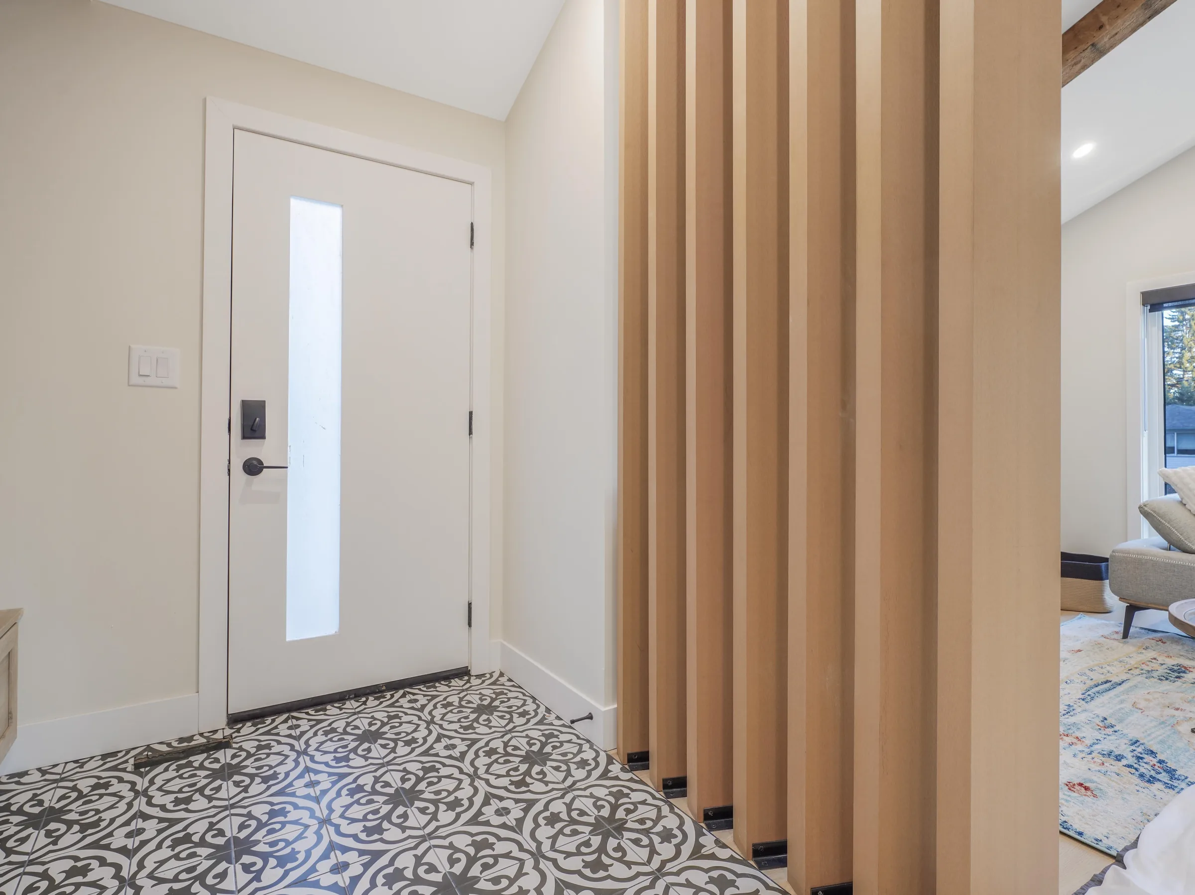 Entry alternate view with a wood slat partition into the living room