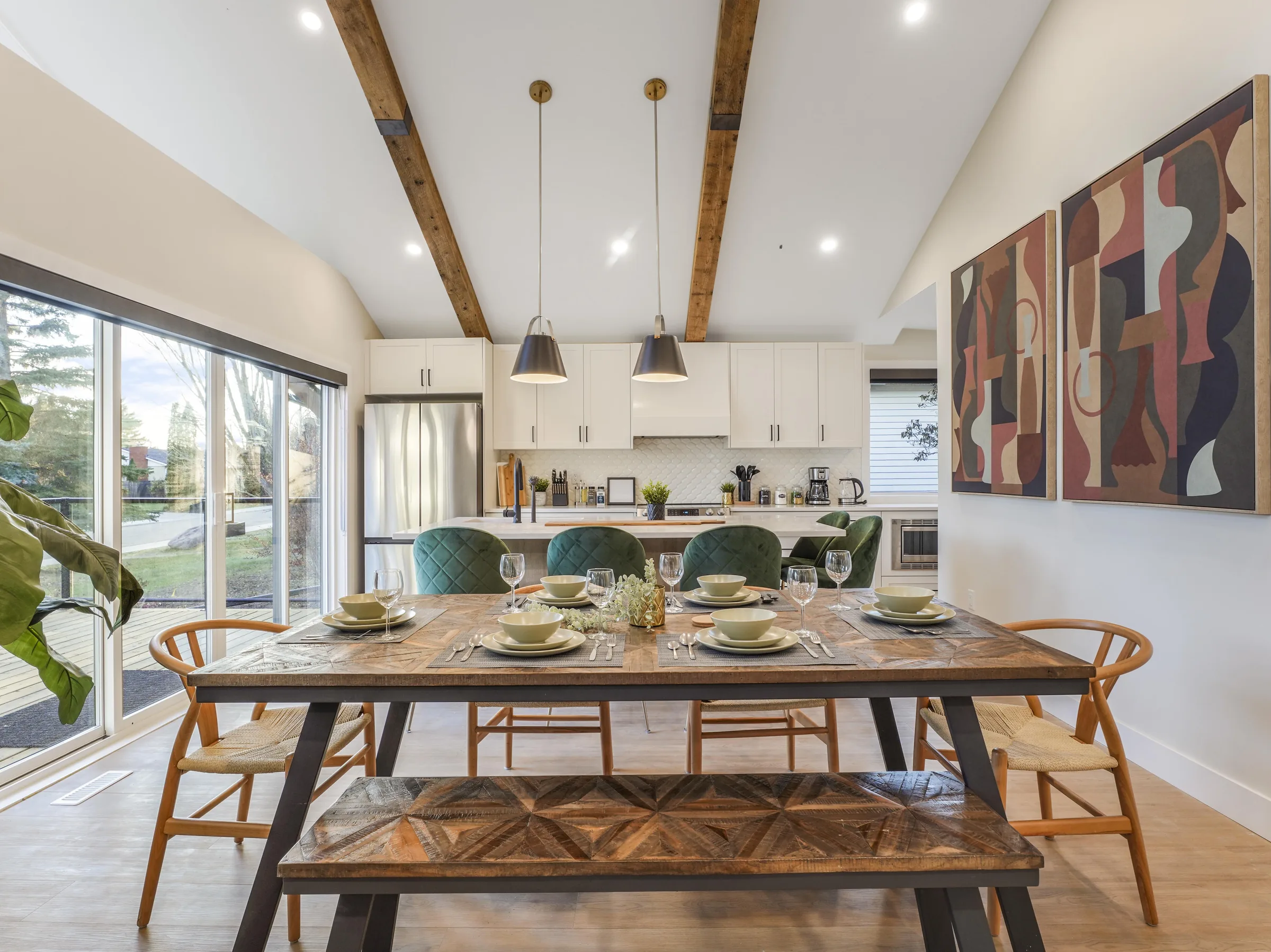 Dining table set with the kitchen visible beyond