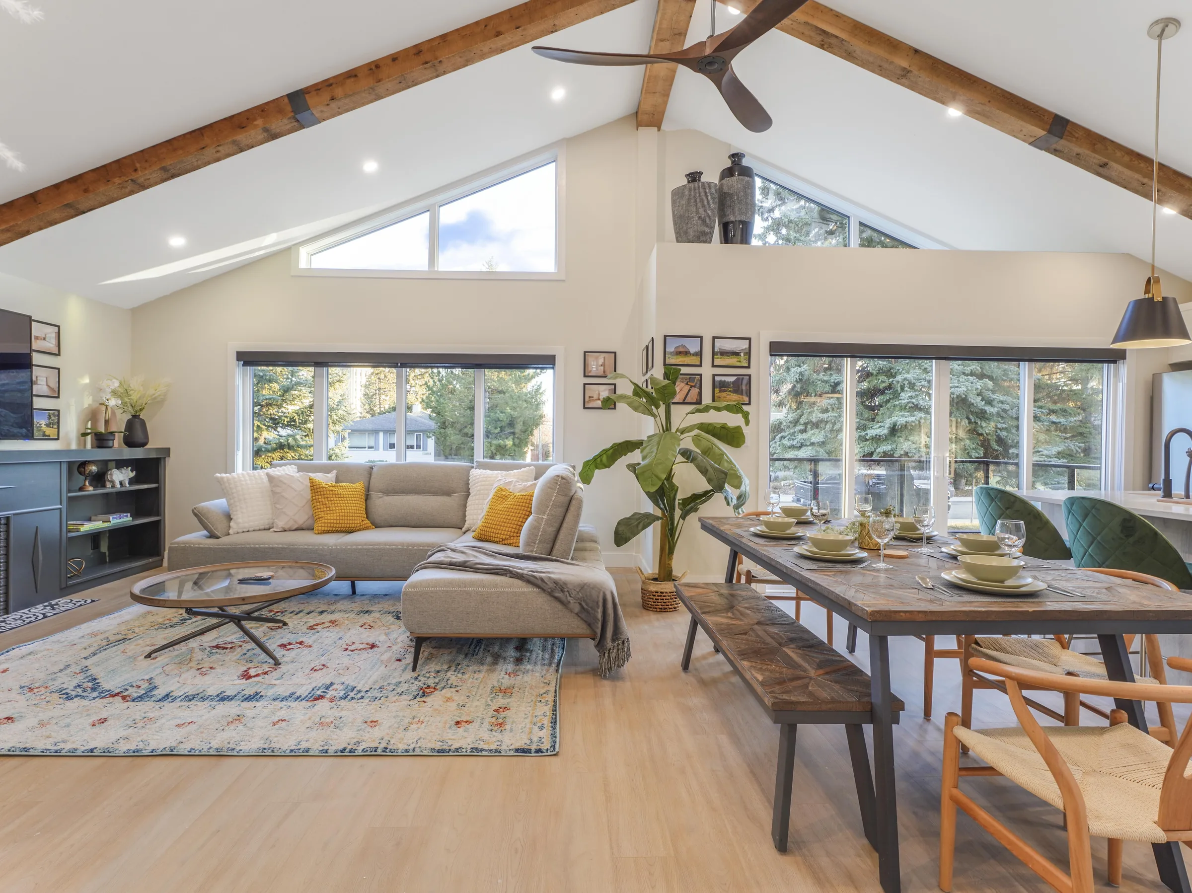 Wide great-room angle showing the dining table and sectional