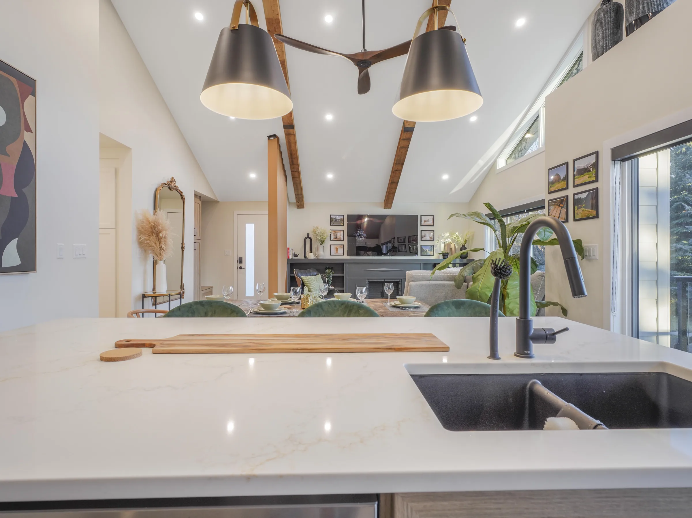 Island sink close-up with dining and living visible beyond