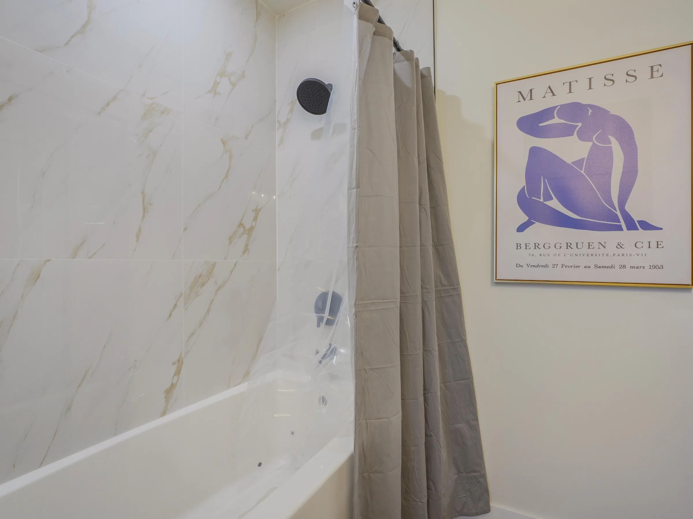 Shower tile close-up with framed poster