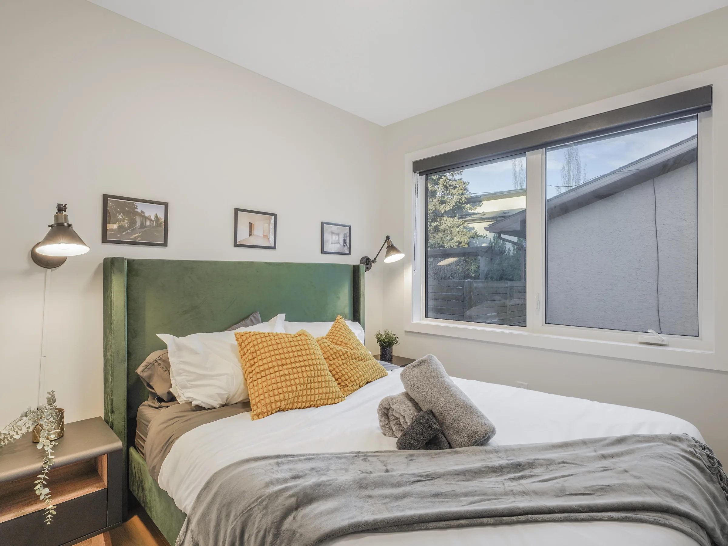 Secondary bedroom with green velvet headboard