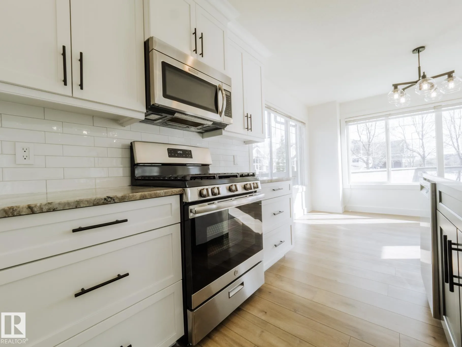 Breakfast nook with corner windows and pendant lighting