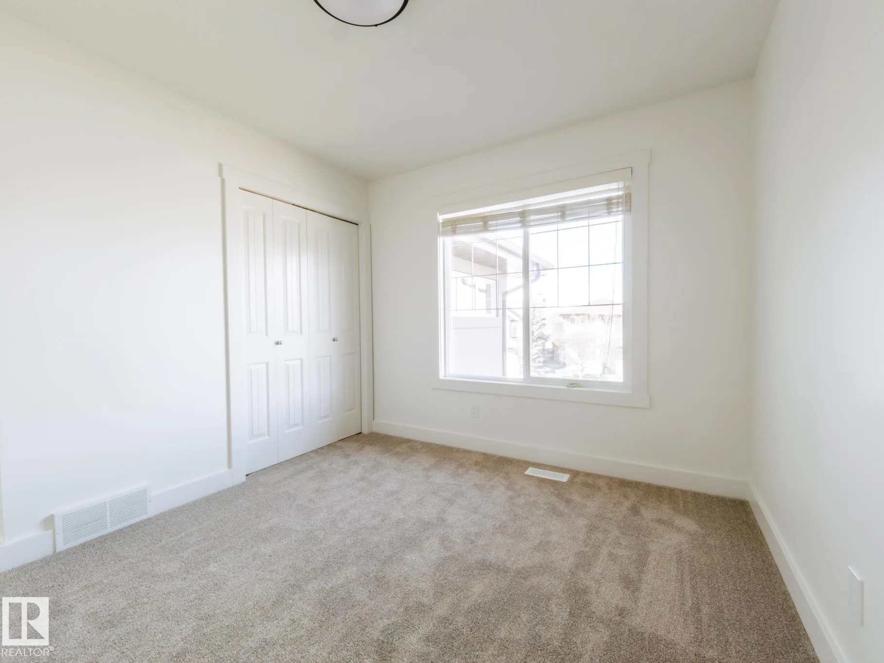 Corner bedroom with windows on two adjoining walls