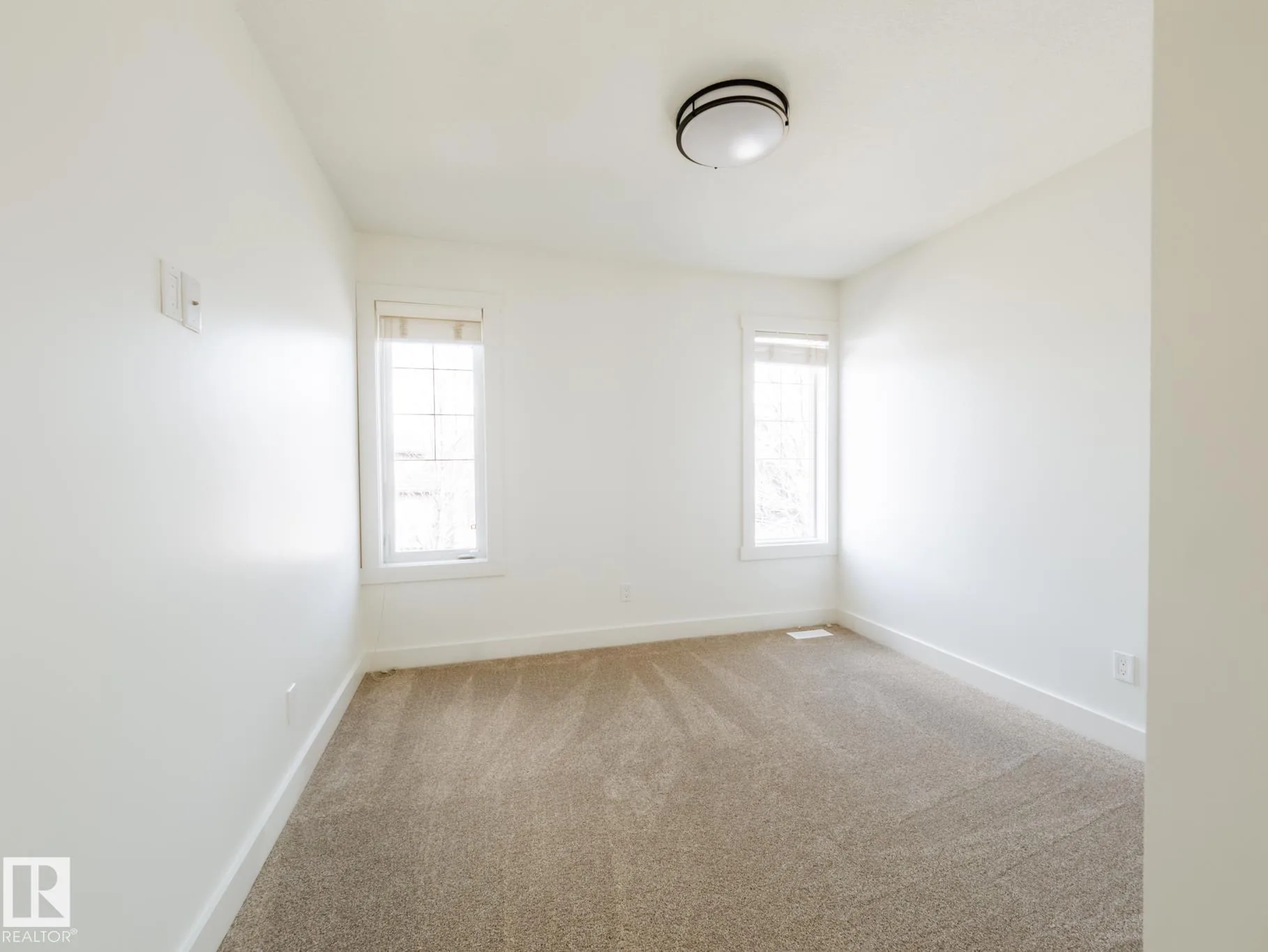 Compact bedroom with a single window and a black drum ceiling fixture