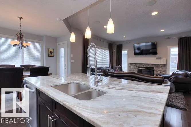 Before renovation, kitchen island with the fireplace in the background
