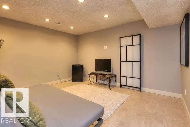 Before renovation, basement family / rec room with tile flooring