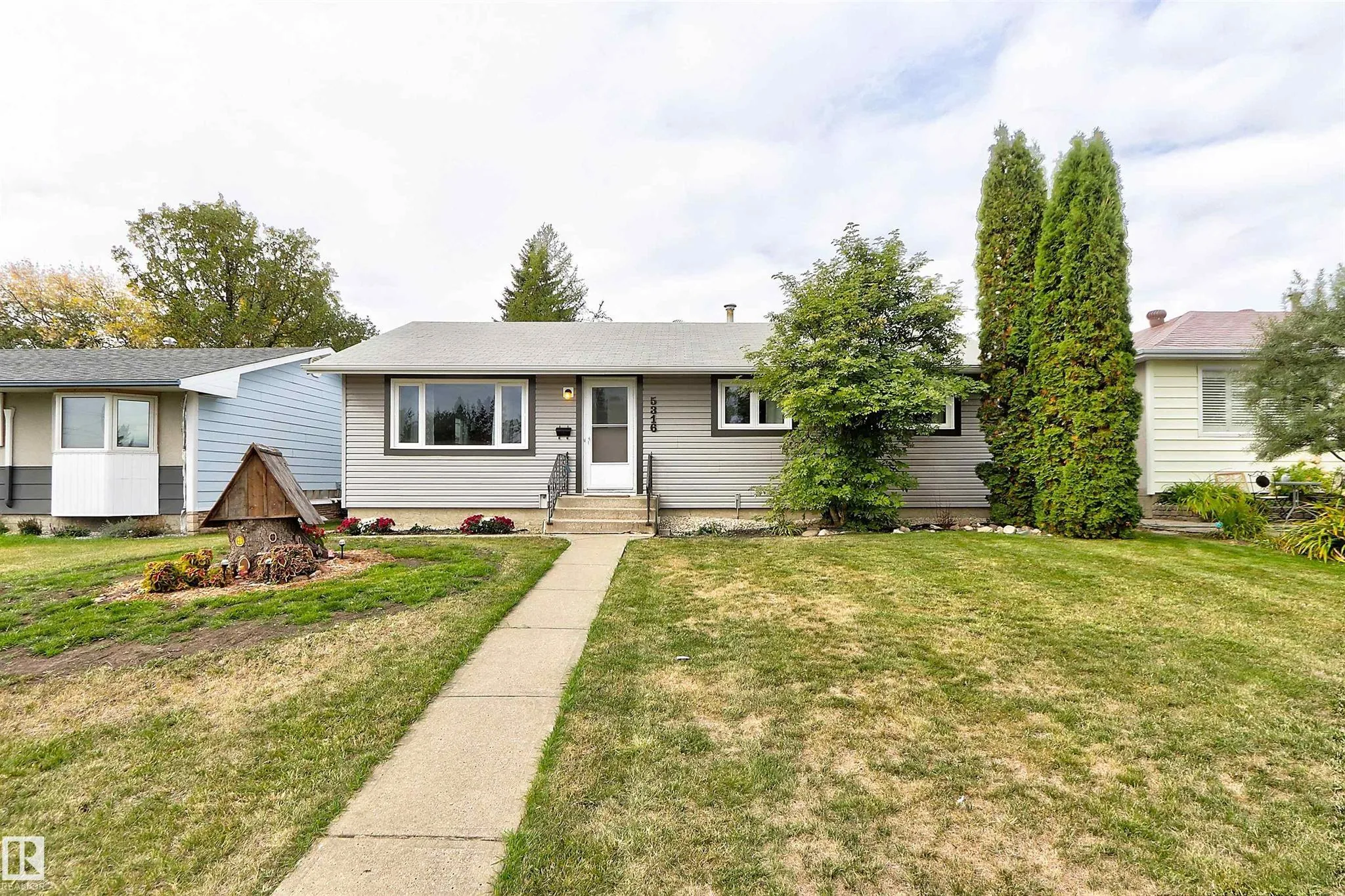 Before, front elevation, original grey siding