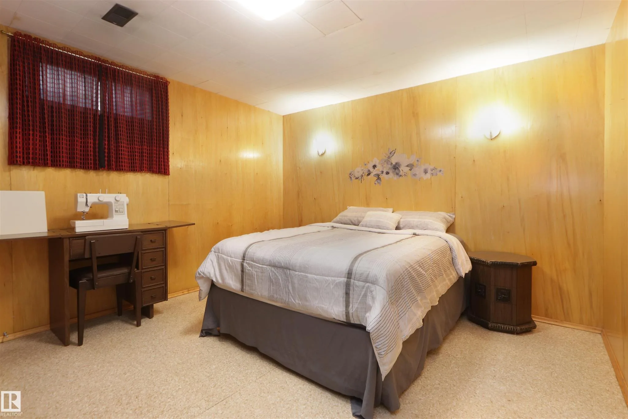 Before, basement wood-panel bedroom