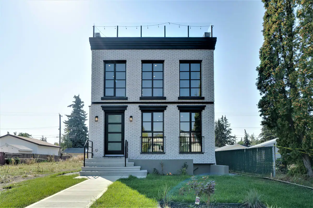 Front elevation, white brick + black windows