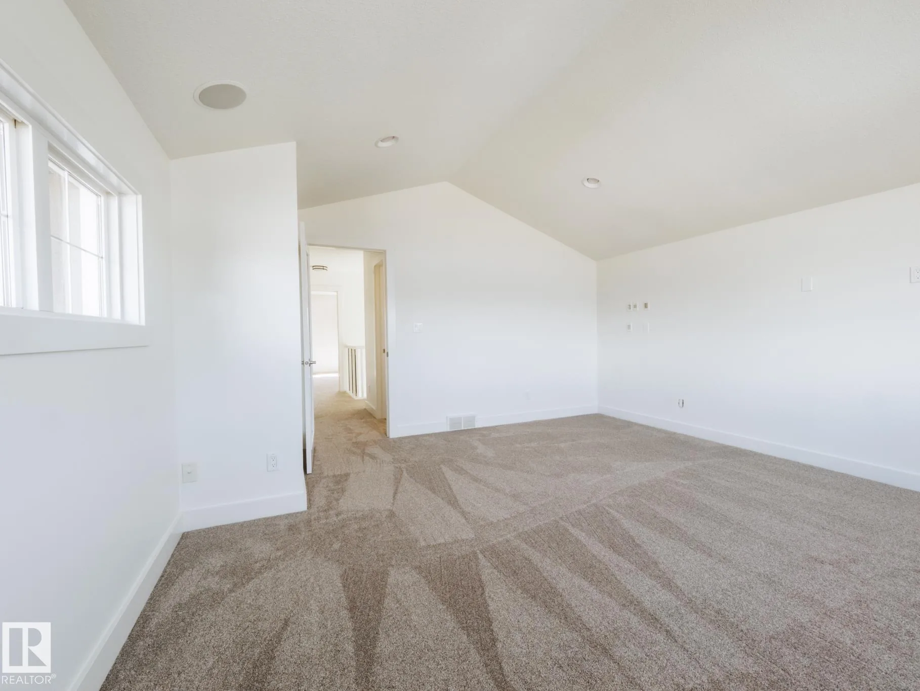 Bedroom with a single window and a black flush-mount ceiling light