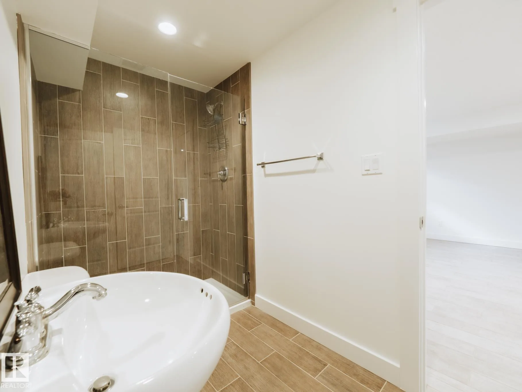 Basement bath with wood-look tile in the shower